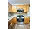 Kitchen featuring granite counters, stainless appliances, and wood cabinets at 3181 Deltona Blvd, Spring Hill, FL 34606