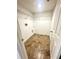 Well-lit laundry room with tile flooring, wire shelving, and washer/dryer hookups at 3181 Deltona Blvd, Spring Hill, FL 34606