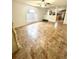 Spacious living area with a large window, tiled flooring, and a partial view into the kitchen at 3181 Deltona Blvd, Spring Hill, FL 34606