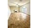 Bright living room showcasing tile floors, a decorative fireplace, and a large window at 3181 Deltona Blvd, Spring Hill, FL 34606