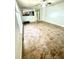 Expansive living room featuring tiled flooring and a ceiling fan, connected to the kitchen area at 3181 Deltona Blvd, Spring Hill, FL 34606
