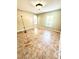 Well-lit living room features tile flooring, a window, and an open archway at 3181 Deltona Blvd, Spring Hill, FL 34606