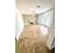 Well-lit living room with tile flooring, a fireplace, and a large window at 3181 Deltona Blvd, Spring Hill, FL 34606