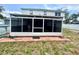 Enclosed patio features screen windows and access to the backyard and pool, blending indoor/outdoor living at 3181 Deltona Blvd, Spring Hill, FL 34606