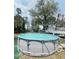 Above-ground pool surrounded by green turf, offering a refreshing backyard retreat at 3181 Deltona Blvd, Spring Hill, FL 34606