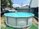 Above-ground pool with ladder, offering a refreshing escape in a private backyard setting at 3181 Deltona Blvd, Spring Hill, FL 34606