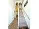 Inviting staircase with carpet runner leading to the upper level of the home at 3181 Deltona Blvd, Spring Hill, FL 34606