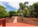 Lush backyard featuring a brick patio, mature trees, and a serene outdoor seating area at 3321 14Th N St, St Petersburg, FL 33704