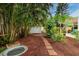 Lush backyard featuring a stepping stone path, mature trees, and privacy at 3321 14Th N St, St Petersburg, FL 33704