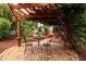 Cozy backyard patio with a pergola, brick flooring, and seating for outdoor relaxation at 3321 14Th N St, St Petersburg, FL 33704
