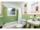 Cozy bathroom featuring a sink, toilet, and bathtub with shower, all in a vibrant, classic style at 3321 14Th N St, St Petersburg, FL 33704