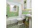 Retro bathroom with green tile and white fixtures at 3321 14Th N St, St Petersburg, FL 33704