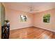 Bedroom with hardwood floors, ceiling fan, and natural light from two windows at 3321 14Th N St, St Petersburg, FL 33704