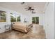 Spacious bedroom with natural light, ceiling fans, and access to a patio through sliding glass doors at 3321 14Th N St, St Petersburg, FL 33704