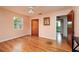 Bedroom with hardwood floors, ceiling fan, and ensuite bathroom at 3321 14Th N St, St Petersburg, FL 33704