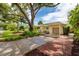 Charming home featuring a well-manicured lawn, mature trees, and a covered carport on a sunny day at 3321 14Th N St, St Petersburg, FL 33704