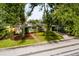Beautiful single-story home with a stone facade, complemented by mature trees and a well-manicured lawn at 3321 14Th N St, St Petersburg, FL 33704