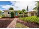 Charming single-story home featuring a stone facade, well-manicured landscaping, and a brick pathway at 3321 14Th N St, St Petersburg, FL 33704