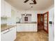 Well-lit kitchen with white cabinetry, granite countertops, and modern appliances with a view to the living space at 3321 14Th N St, St Petersburg, FL 33704