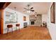 Spacious living room with a stone fireplace, ceiling fans, and connecting kitchen area at 3321 14Th N St, St Petersburg, FL 33704