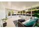 Bright sunroom with a seating area, large windows, and a view of the lush backyard at 3321 14Th N St, St Petersburg, FL 33704