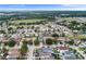 This aerial view shows a neighborhood featuring a mix of homes, landscaping, and natural surroundings at 3351 Lintower Dr, Land O Lakes, FL 34638