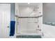 Modern bathroom showcasing tiled tub and shower with glass partition and grab bar at 3351 Lintower Dr, Land O Lakes, FL 34638