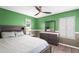 Brightly painted bedroom features dark wood accents, neutral bedding and a ceiling fan at 3351 Lintower Dr, Land O Lakes, FL 34638