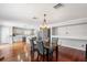 A bright dining area transitions into an open kitchen, boasting hardwood floors and recessed lighting at 3351 Lintower Dr, Land O Lakes, FL 34638