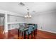 A stylish dining area featuring hardwood floors, with a modern chandelier above the glass table at 3351 Lintower Dr, Land O Lakes, FL 34638