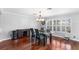 Dining room featuring hardwood floors, a modern light fixture, and a glass table with leather chairs at 3351 Lintower Dr, Land O Lakes, FL 34638