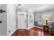 Entryway showcasing beautiful hardwood floors, a decorative chandelier and large window with shutters at 3351 Lintower Dr, Land O Lakes, FL 34638