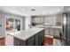 Spacious kitchen featuring a large island, stainless steel appliances, and access to outdoor space at 3351 Lintower Dr, Land O Lakes, FL 34638