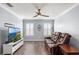 Cozy living room featuring a leather sofa, TV, and modern ceiling fan at 3351 Lintower Dr, Land O Lakes, FL 34638