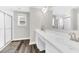 Bright bathroom features a double sink vanity with ample counter space and a tiled walk-in shower at 3602 W Iowa Ave, Tampa, FL 33611