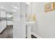 Modern powder room featuring pedestal sink, round mirror and decorative wall art at 3602 W Iowa Ave, Tampa, FL 33611