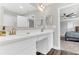 Bright bathroom with double sink vanity featuring quartz countertops and bronze faucets at 3602 W Iowa Ave, Tampa, FL 33611