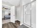 Bright bathroom showing walk-in shower with glass doors and view into the main bedroom at 3602 W Iowa Ave, Tampa, FL 33611