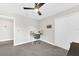 Bedroom featuring a desk, carpeted floors, neutral walls, a ceiling fan, and a closet at 3602 W Iowa Ave, Tampa, FL 33611