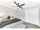 Bedroom features neutral walls, carpeted floors, a ceiling fan, and a closet at 3602 W Iowa Ave, Tampa, FL 33611