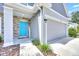 Inviting front entrance with a vibrant blue door, stone accents, and a welcoming walkway at 3602 W Iowa Ave, Tampa, FL 33611