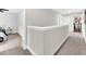 Upstairs hallway with carpeted floors, neutral walls, and white trim and doors at 3602 W Iowa Ave, Tampa, FL 33611