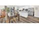 Modern kitchen and dining area with stainless appliances, island, wood floors and sliding glass doors at 3602 W Iowa Ave, Tampa, FL 33611