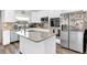 Bright kitchen features white cabinets, stainless steel appliances and a center island with sink at 3602 W Iowa Ave, Tampa, FL 33611