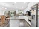 Modern kitchen showcasing stainless appliances, center island and light-filled dining area with sliding glass doors at 3602 W Iowa Ave, Tampa, FL 33611
