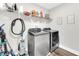 Laundry room featuring modern washer and dryer and upper storage shelves at 3602 W Iowa Ave, Tampa, FL 33611