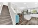 Open-concept living area with staircase, kitchen, dining area, and living room at 3602 W Iowa Ave, Tampa, FL 33611
