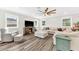 Cozy living room with hardwood floors, lots of natural light and an expansive ceiling fan at 3602 W Iowa Ave, Tampa, FL 33611