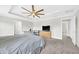 Spacious main bedroom features carpeted floors, a ceiling fan, and lots of windows at 3602 W Iowa Ave, Tampa, FL 33611