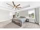 Spacious main bedroom features carpeted floors, a ceiling fan, and lots of windows at 3602 W Iowa Ave, Tampa, FL 33611